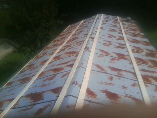 Rusted metal roof panels with new wood purlins before replacement — Storm Damage Roof Repair in Tensed by Roofing Brothers